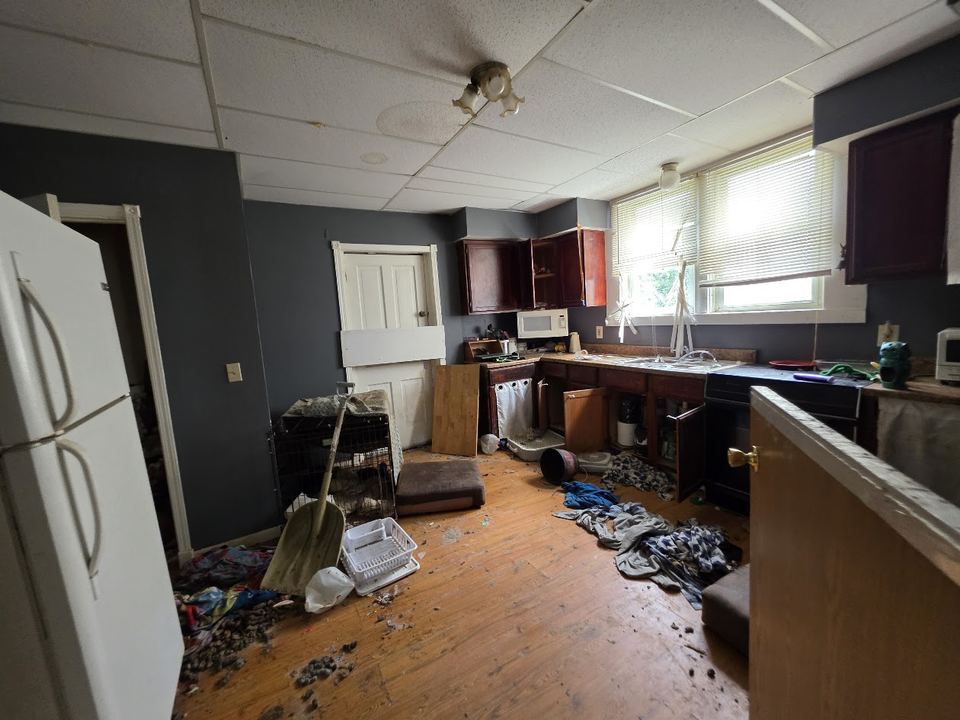 Before: Trashed kitchen with debris on the floor. Cleaned out and rebuilt.