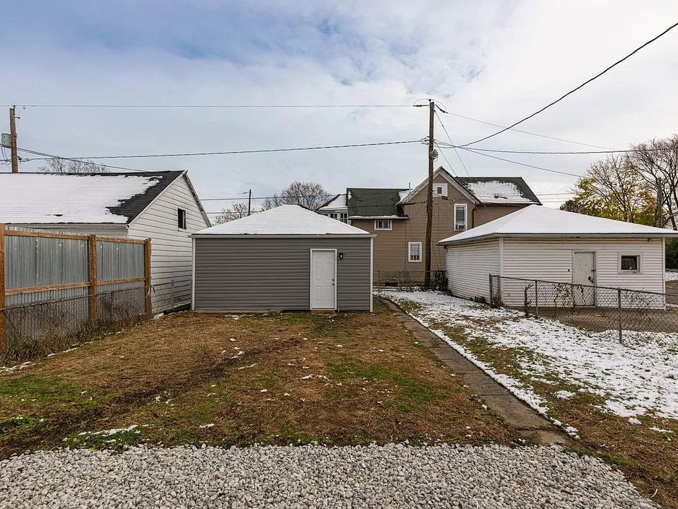 After: Overgrown yard and a worn-out garage. Cleared out and re-sided.
